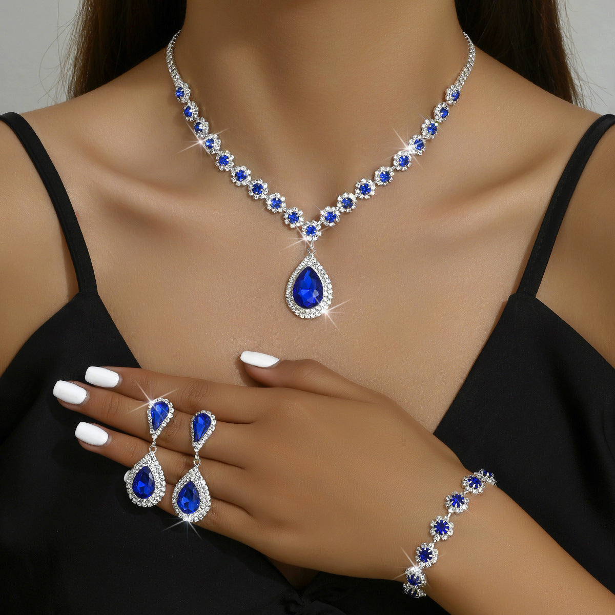 Blue rhinestone bridal jewelry set with round stone necklace, drop earrings, bracelet and rings