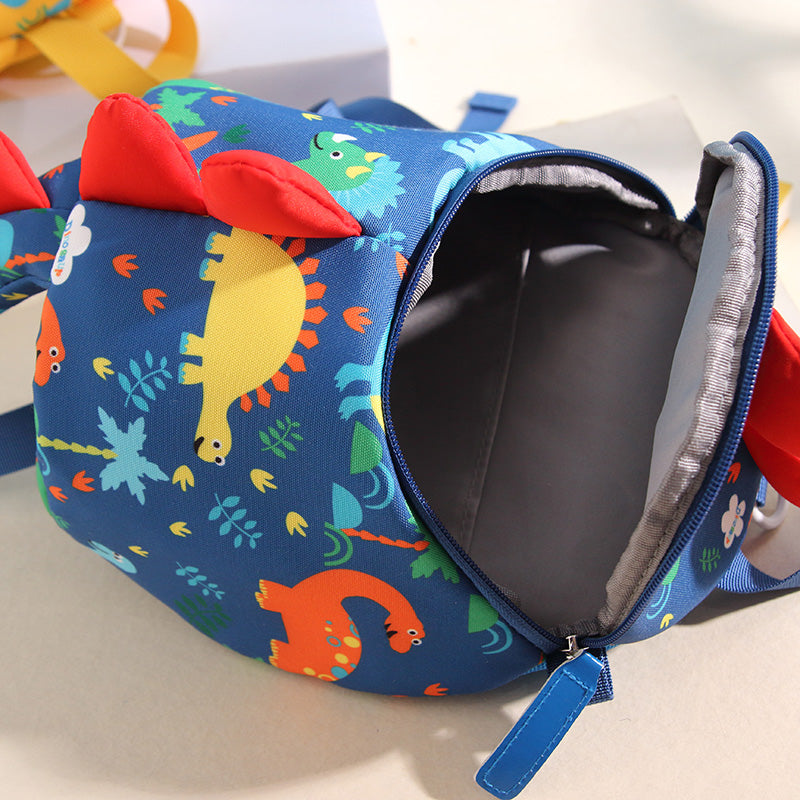 Kids small backpack open view, dark interior and zipper on blue dinosaur print bag