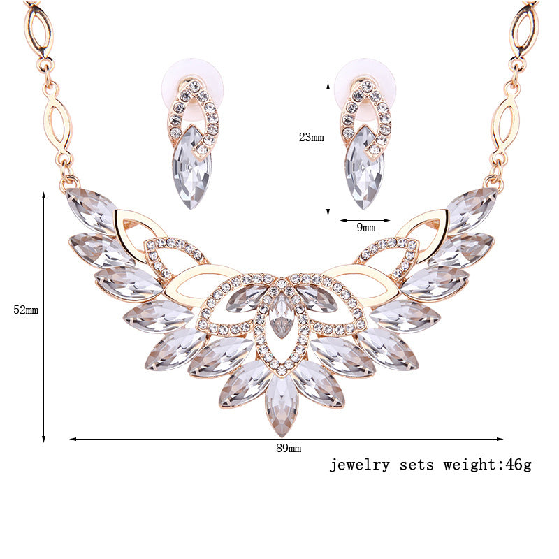 Crystal pendant necklace with matching drop earrings, rose-gold tone setting