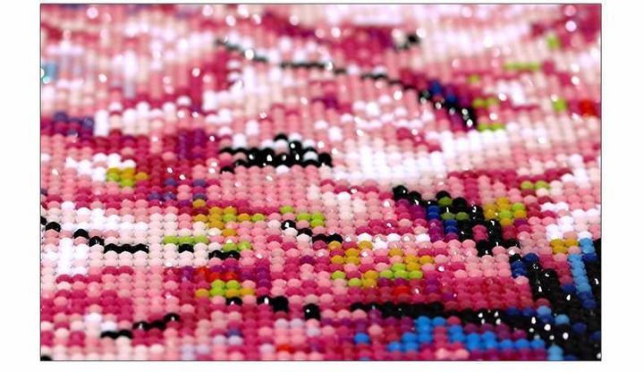 5D diamond painting beads close-up with pink, white, and multicolor resin gems
