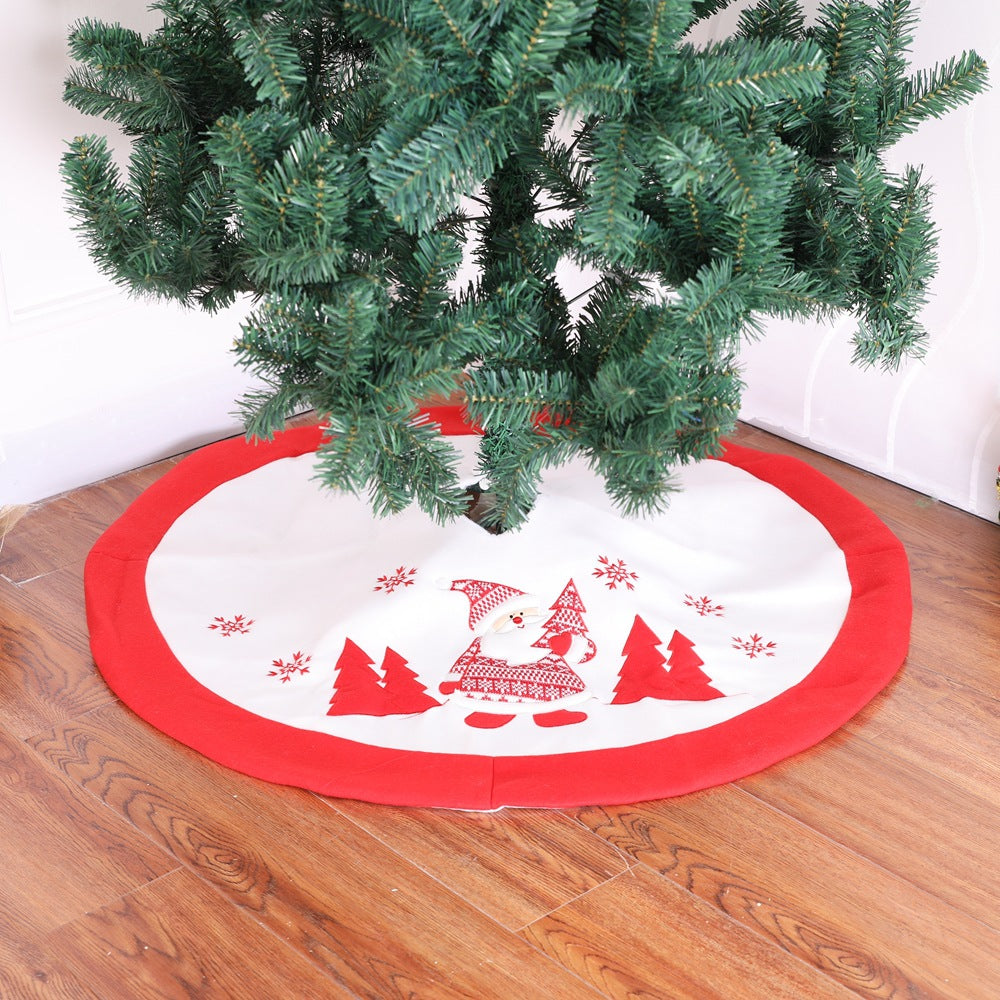 Red and white Christmas tree skirt with Santa graphic, trees, snowflakes, and circular border