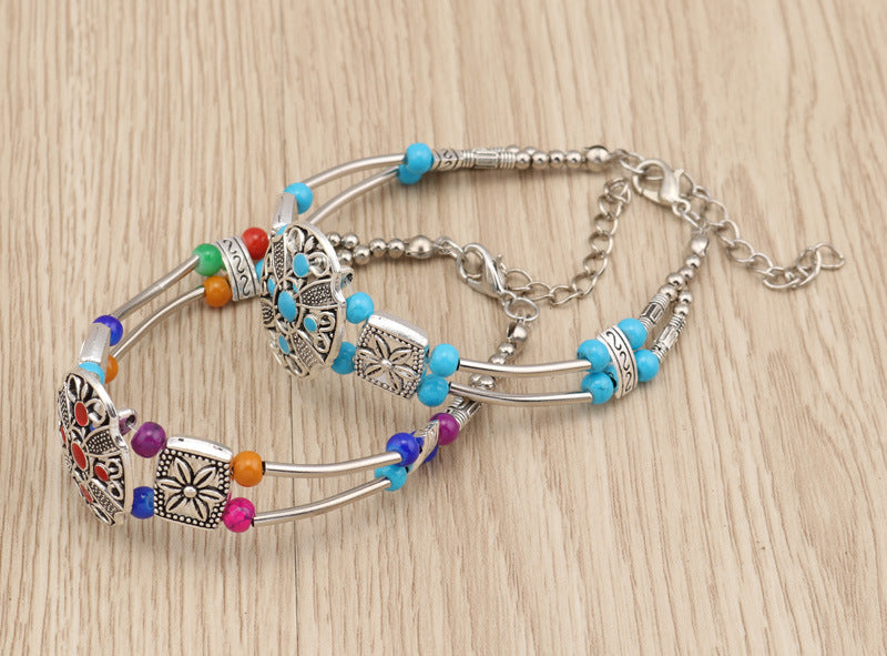 Silver-tone double-row bead bracelet with turquoise, purple, and orange beads and clasp