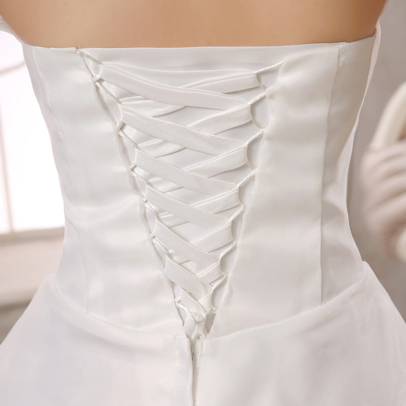 White corset-style wedding dress back with crisscross lace-up detailing