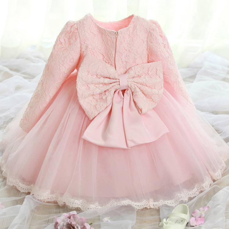 Girls lace princess dress in pale pink with long lace sleeves, bow detail, tulle skirt