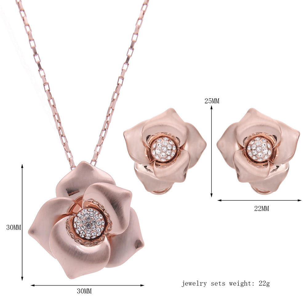Rose gold flower pendant necklace and matching crystal stud earrings, set shown