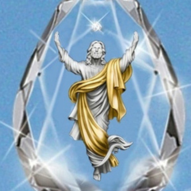 Faceted crystal pendant with angel figure, silver-toned frame and gold drape detail