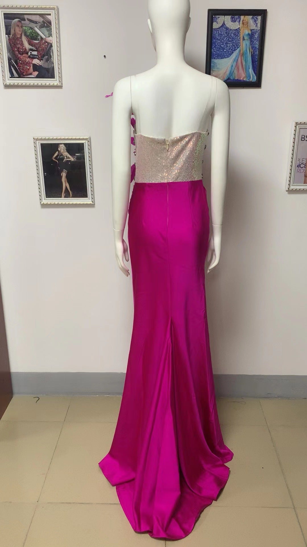 Mannequin wearing dark pink one-piece dress with glittery bandeau and feather-trim straps