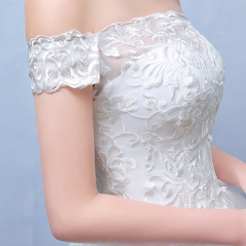 White off-shoulder lace wedding dress bodice with floral embroidery and scalloped trim