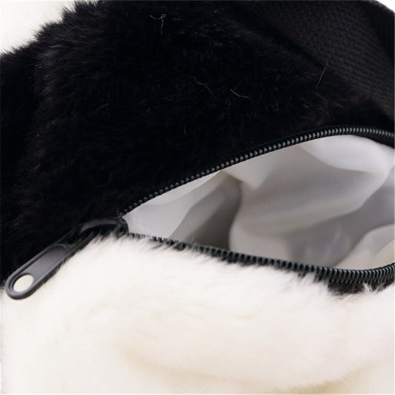 Plush panda backpack front pocket with black zipper and smooth fabric interior.