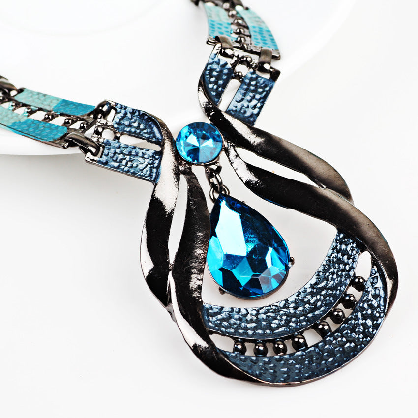 Blue teardrop pendant necklace with matching drop earrings, silver-tone settings