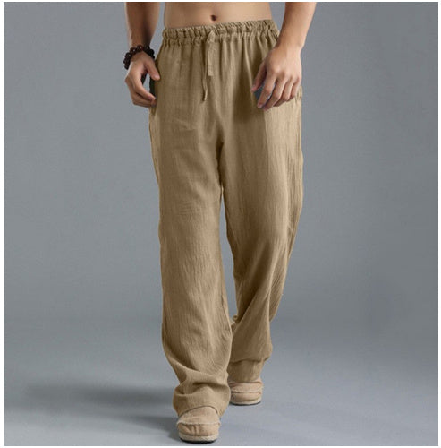 Loose beige linen sports pants with elastic drawstring waist and relaxed straight legs