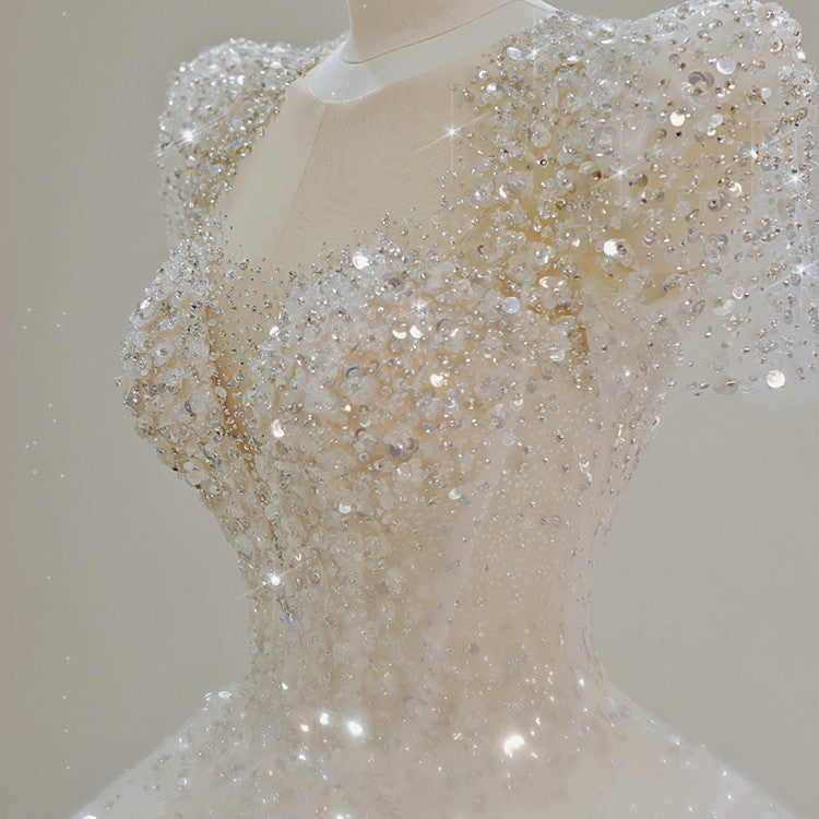 White sequined bridal bodice close-up on mannequin with off-shoulder detail
