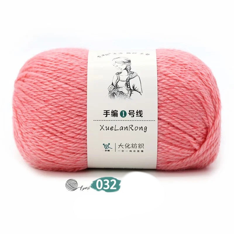 Hand-knitted scarf yarn ball in light pink with chunky twisted texture.