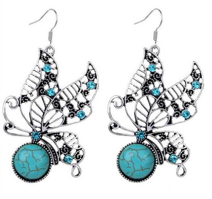 Turquoise cabochon drop earrings with silver-tone hollow butterfly details and teal stones