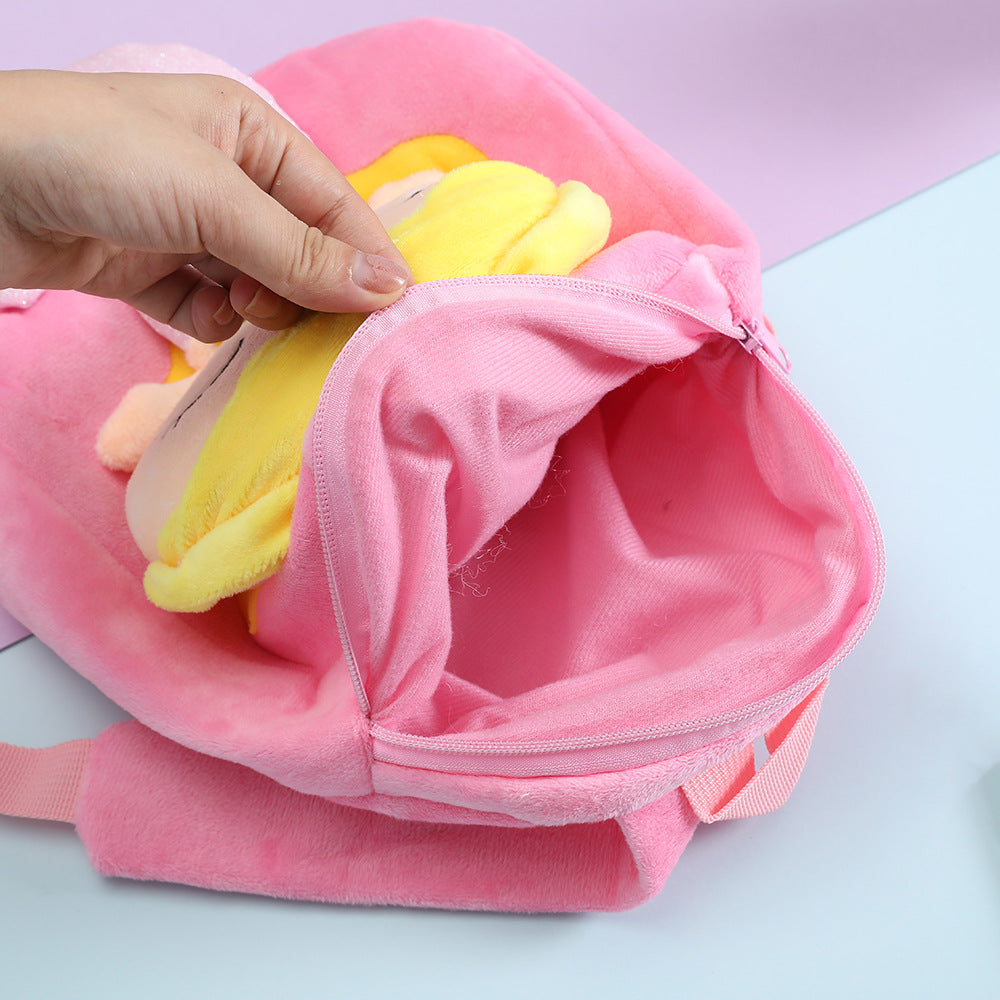 Pink plush kids backpack open with inner fabric lining and zip closure visible