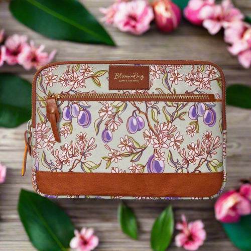 Floral-patterned pouch with brown accents on a white background