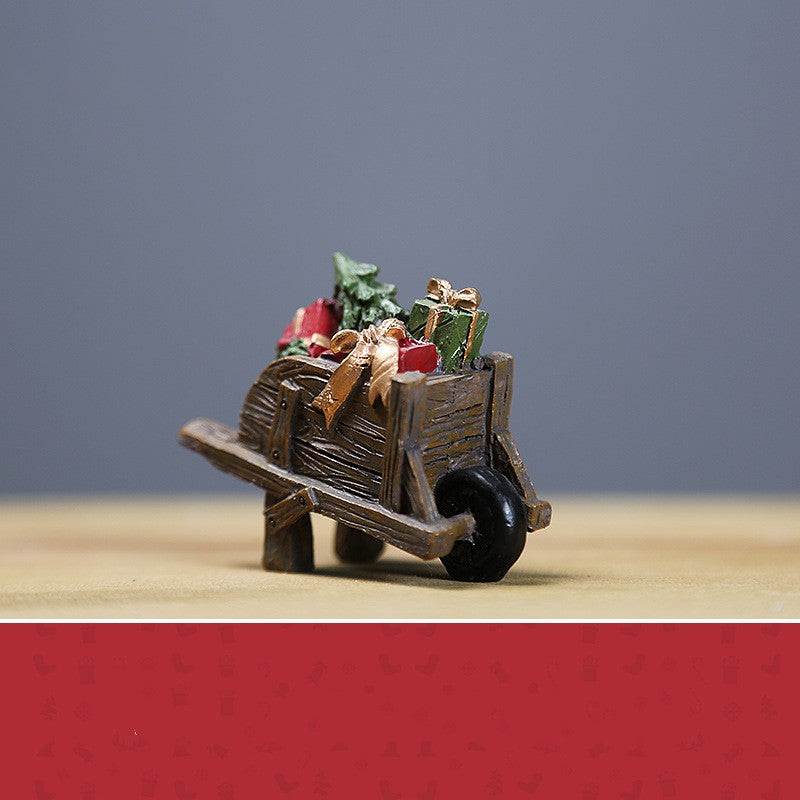 Miniature ornament: brown wheelbarrow filled with wrapped gifts and greenery