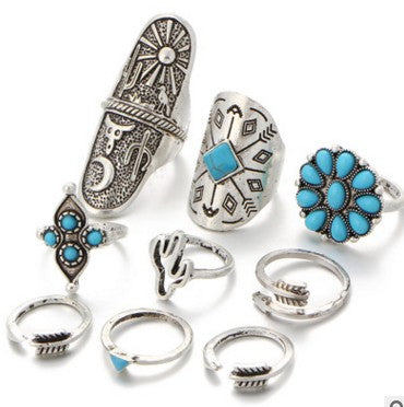 Boho vintage ring set flat lay: turquoise flower, hamsa-style, engraved silver rings