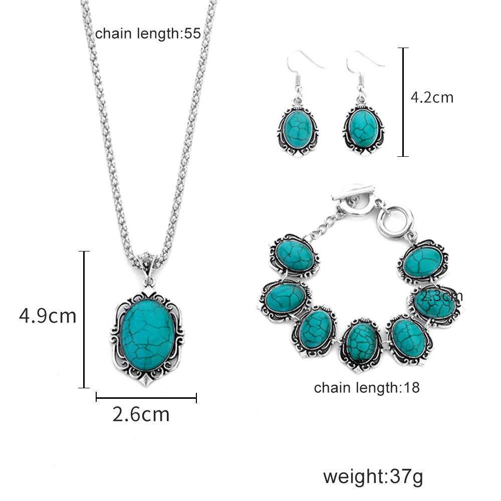 Turquoise cabochon jewelry set: pendant necklace, drop earrings, and link charm bracelet.