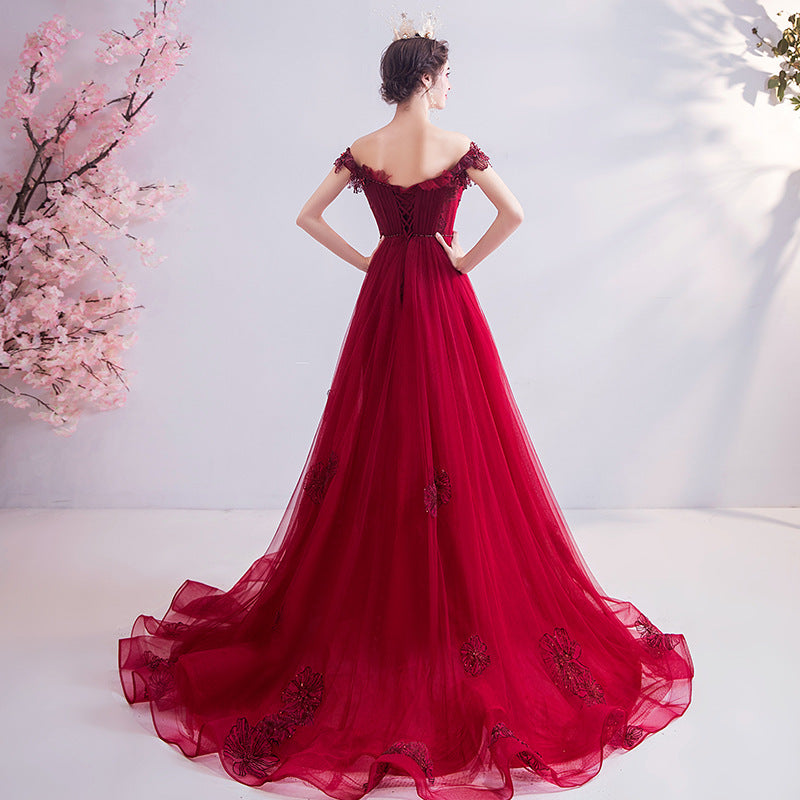 Red off-shoulder evening gown with fitted back and full tulle skirt