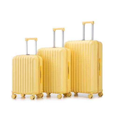 Three-piece ABS spinner luggage set, yellow ribbed shells with telescoping handles.