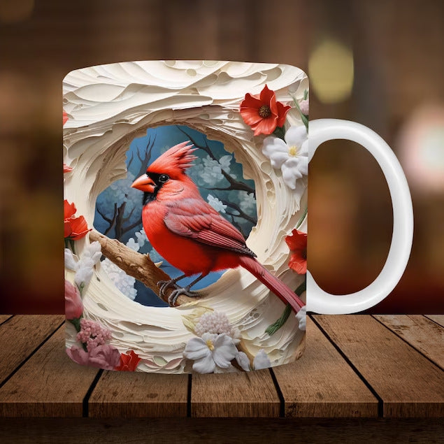 Ceramic coffee mug with a red cardinal perched in a floral wreath, white handle