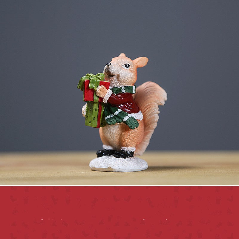 Miniature ornament fawn figurine holding wrapped gifts in red and green clothing