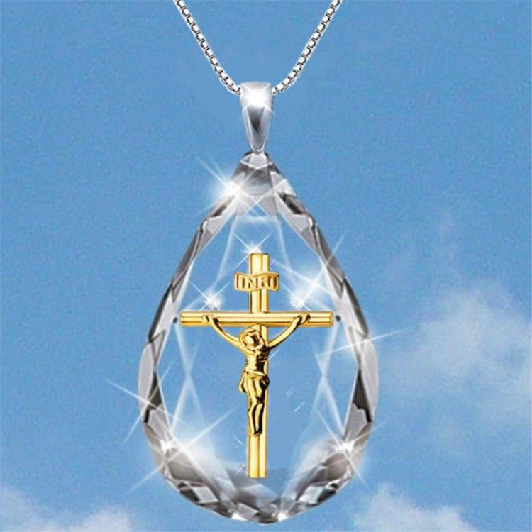 Gold-tone crystal teardrop pendant with crucifix charm on a chain