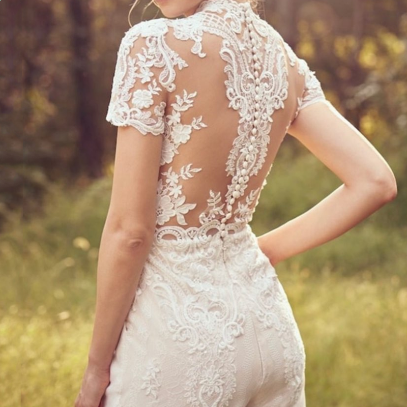 White lace bridal short-sleeve jumpsuit bodice with floral appliques and high collar