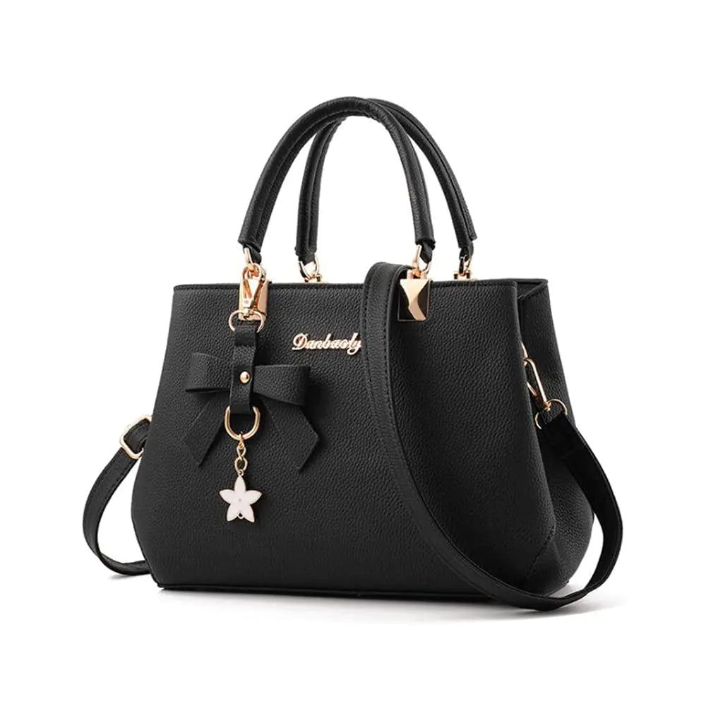 Black bow satchel handbag with top handles, crossbody strap, and butterfly charm