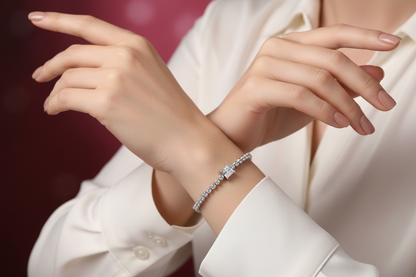 Silver diamond-style tennis bracelet on white sleeve