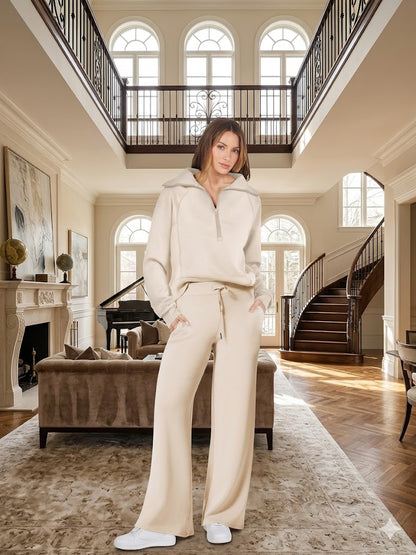 Off-white two-piece tracksuit with quarter-zip long-sleeve top and wide-leg pants