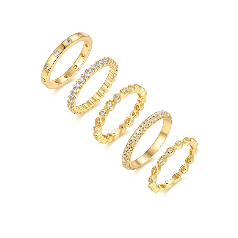 Five gold-tone rings with round and pavé stones, flat lay set