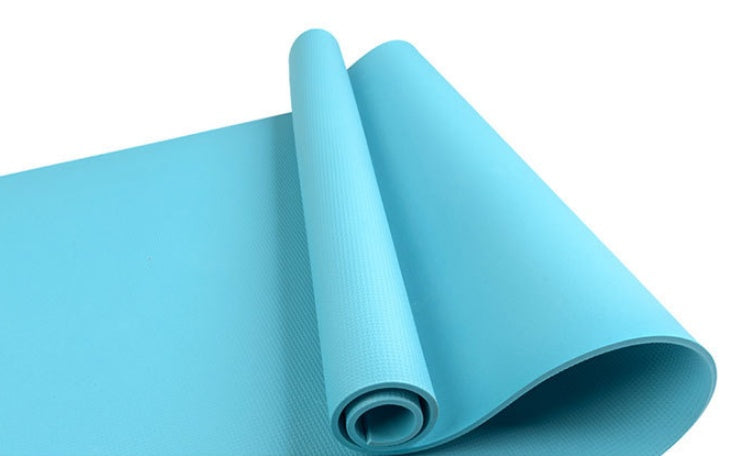 Light blue yoga mat rolled, with ribbed texture along the surface