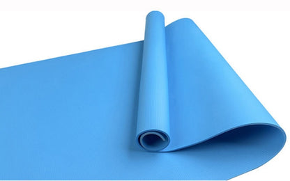 Blue fitness yoga mat, rolled with textured surface and visible open end
