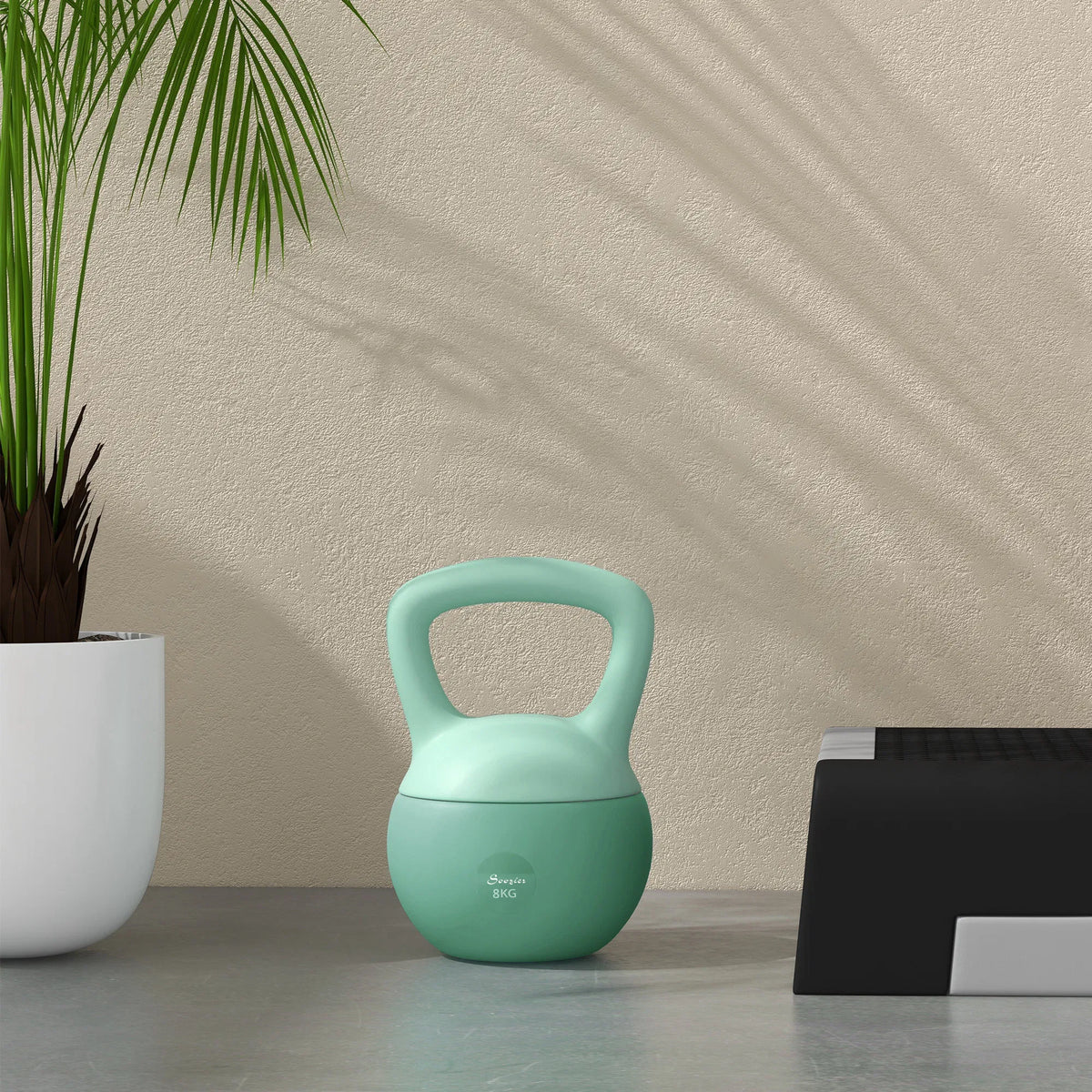Green soft kettlebell with handle and stable flat base on the floor