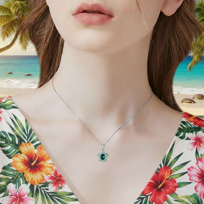 Close-up: silver turtle pendant necklace with green crystal drop on chain