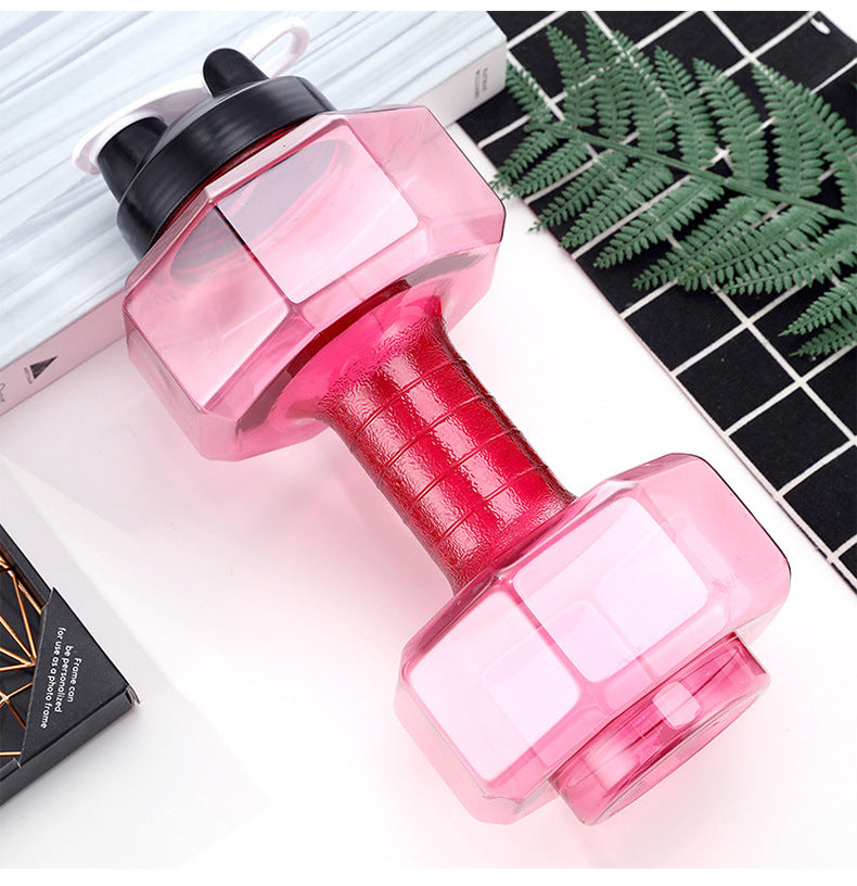 Portable water-injection dumbbell, pink body and red textured grip with clear plates