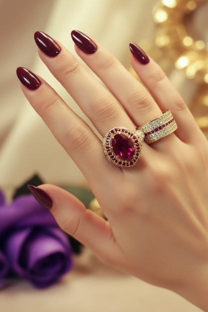 Diamond-style ladies ring with pink-red oval center stone and pavé band
