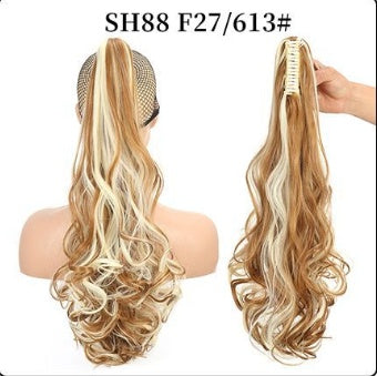 Claw clip ponytail hair extension with long curly waves, light caramel brown hair.
