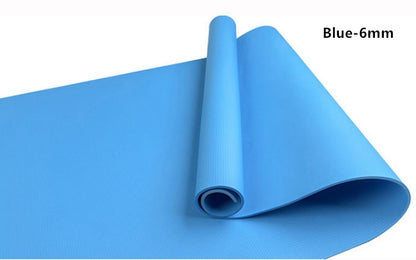 Blue yoga mat laid flat, showing rolled-up center and smooth surface