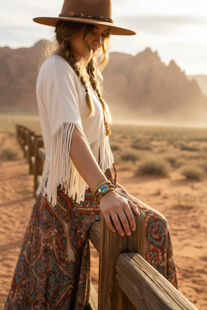 Turquoise bead and leather chain bracelet on wrist with gold-tone accents