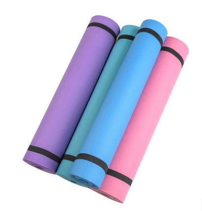 Set of rolled yoga mats in purple, teal, blue, and pink with black bands