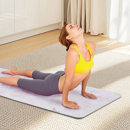 Pink floral print yoga mat used for floor exercises, shown flat on rug