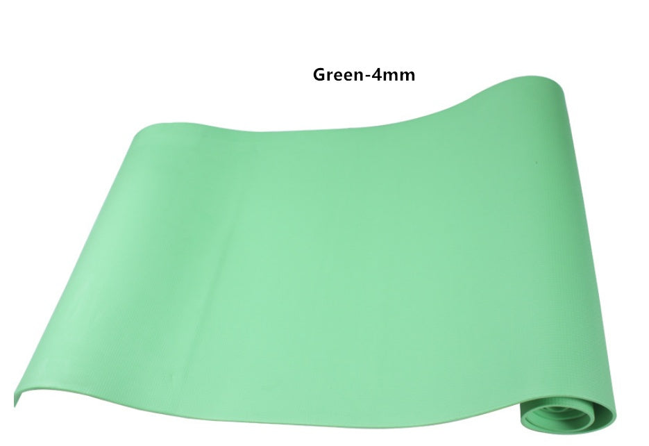 Green yoga mat laid out, rolled corner visible and smooth surface