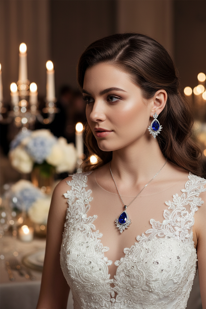 Bridal necklace with blue teardrop pendant and matching ornate earrings