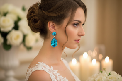 Blue teardrop crystal drop earrings with dangling charm, silver-tone setting