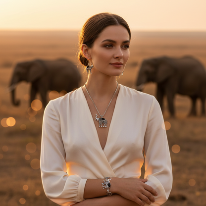 Elephant jewelry set on model: silver-tone elephant pendant necklace and matching earrings.