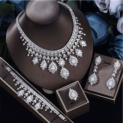 Silver-tone necklace and earring set with clear rhinestone flower motifs and matching bracelet