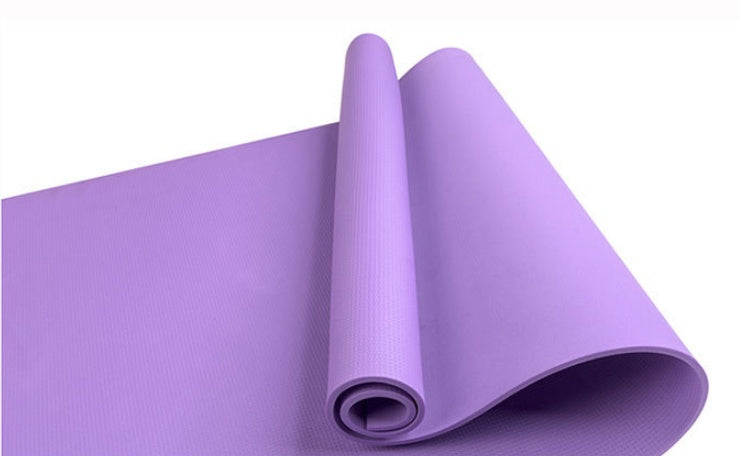 Purple fitness yoga mat, rolled with textured surface and visible open end